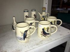 A quantity of Brixham pottery bird decorated pottery including 4 mugs,