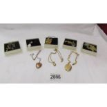 Six various pendants and two lockets.