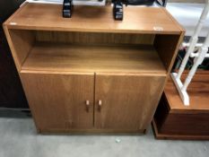 A teak veneered 2 door cupboard