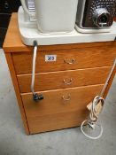 A small three drawer chest.