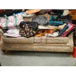A two seat sofa on brass castors (collect only)