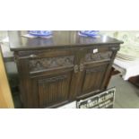 An oak two door cupboard.