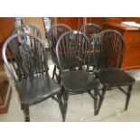 A set of 6 wheel back chairs.