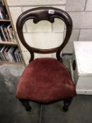 A Victorian mahogany balloon back chair with turned legs
