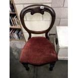 A Victorian mahogany balloon back chair with turned legs