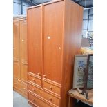 A teak 2 door wardrobe with 4 drawers.