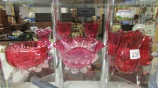 Eight pieces of cranberry glass.