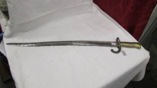An old bayonet with brass hilt, No. A29926.