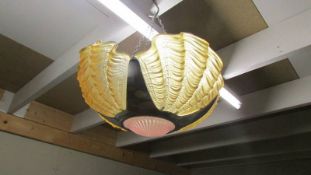 An art deco four amber clam shell uplighter ceiling light.