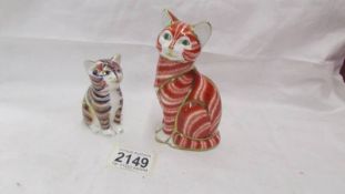 Two Royal Crown Derby cat paperweights both with gold stoppers.