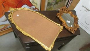 A shield shaped mirror and a gilt mirror frame.