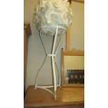 A wrought iron wash stand and a paper lamp shade.