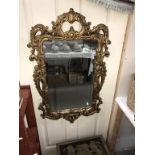 A decorative gilt framed mirror (92cm x 54cm) (Collect only)