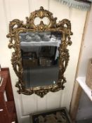A decorative gilt framed mirror (92cm x 54cm) (Collect only)