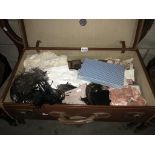A large vinatge suitcase with vintage textiles including lace, ostrich feathers, handkerchiefs,