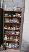 Seven shelves of interesting china.