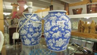 A pair of blue and white Chinese style table lamp bases (one with fittings, one without),