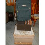 Two foot stools and a suitcase.