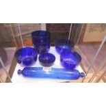 A Bristol blue glass rolling pin and seven blue glass bowls.