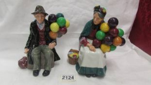 Two Royal Doulton figurines - "The Balloon Man" HN 1954 and "The Old Balloon Seller" HN 1315.