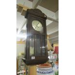 An Edwardian oak 8 day wall clock with key.