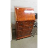 A small modern mahogany inlaid bureau.