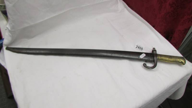 An old bayonet with brass hilt, No. S29940.