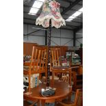 A barley twist wooden standard lamp with shade.