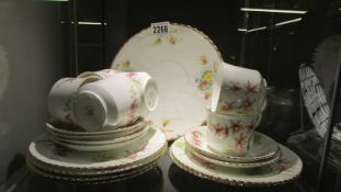 An Aynsley floral patterned tea set (missing sugar bowl) with an odd sandwich plate.