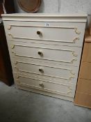 A four drawer bedside chest.