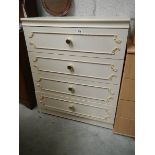 A four drawer bedside chest.