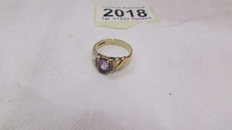 An oval amethyst ring set with diamond shoulders, 375 9ct gold, size O half. - Image 3 of 3