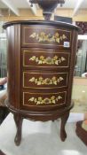 A good quality oval mahogany inlaid four drawer chest.