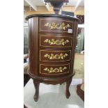 A good quality oval mahogany inlaid four drawer chest.