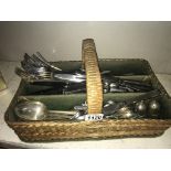 A wicker cutlery tray & selection of flat ware