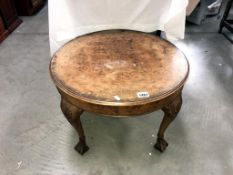 A 1920's walnut veneered coffee table on Anthemion embellished legs with ball & claw feet