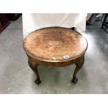 A 1920's walnut veneered coffee table on Anthemion embellished legs with ball & claw feet