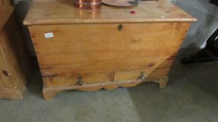 A pine blanket box with 2 drawers.