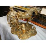 A solid brass figure of a blacksmith.