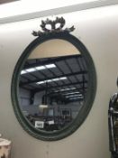 A shabby chic oval mirror