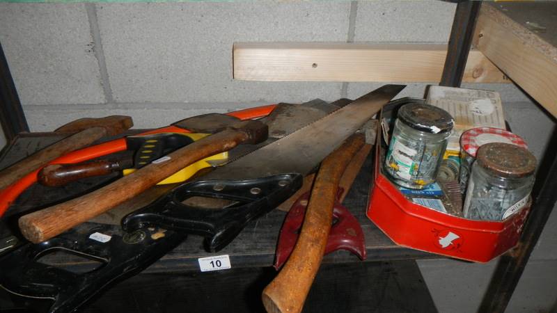 A shelf of saws, axes etc.