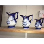 A set of 3 graduated blue Staffordshire pottery jugs