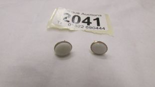 A pair of 9ct gold earrings set natural opals.