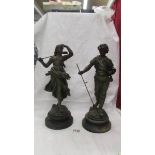 A pair of spelter figures, 38 cm tall.