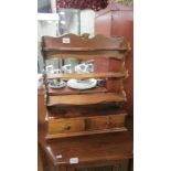 A mahogany shelf with two drawers.