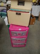 A pink plastic chest of drawers and a file case.