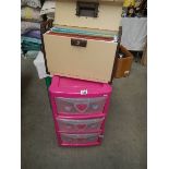 A pink plastic chest of drawers and a file case.