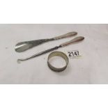 A silver handled button hook, a silver handled shoe horn and a silver napkin ring.