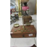 A set of brass postal scales on mahogany drawer base.