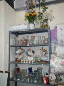 Four shelves of assorted china and glass ware.